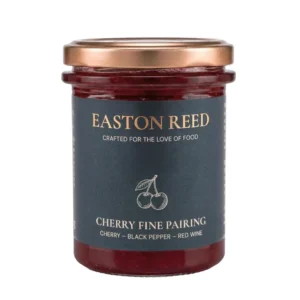 Cherry Black Pepper Red Wine Fine Pairing im Glas mit Käse, dunklem Brot und Rotwein serviert.