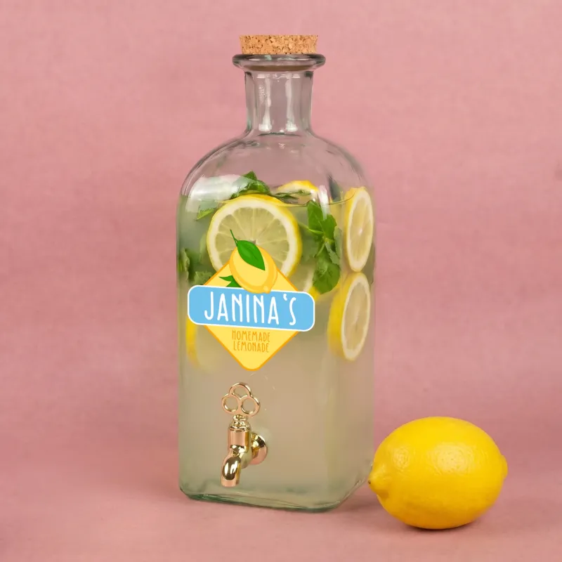 Personalisierter Glas Getränkespender mit Zitronen-Motiv, Name Janinas und gefüllter Limonade mit Zitronenscheiben und Minze